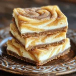 - 1 ½ cups all-purpose flour - ½ teaspoon baking powder - ½ teaspoon ground cinnamon - ½ teaspoon salt - ½ cup (1 stick) unsalted butter, softened at room temperature - 1 cup packed brown sugar - 1 large egg, at room temperature - 1 teaspoon pure vanilla extract - 8 oz cream cheese, softened to room temperature - ½ cup granulated sugar - 1 teaspoon fresh lemon juice - 1 tablespoon cinnamon sugar (for topping) For these churro cheesecake bars, I use simple ingredients. Each one adds to the flavor and texture. The all-purpose flour forms the base. The baking powder helps them rise. Ground cinnamon gives that classic churro taste. Salt balances the sweetness. I always choose unsalted butter because it gives me control over salt levels. Brown sugar is key for its rich taste. It makes the bars moist and chewy. The egg adds structure, while vanilla brings warmth. The cream cheese is the star of the show. Its richness gives a creamy filling. Granulated sugar sweetens it just right. Fresh lemon juice adds a touch of brightness. Finally, the cinnamon sugar topping is like the cherry on top. It makes everything feel special. These ingredients come together for a delightful treat. They make your kitchen smell amazing while baking. You will find the full recipe to guide you through each step. - Preheat the oven to 350°F (175°C). - Line the baking pan with parchment paper. - Whisk together flour, baking powder, cinnamon, and salt. - Beat softened butter and brown sugar together until creamy. - Add egg and vanilla, mix until blended. - Fold in dry ingredients and layer in the baking pan. - Prepare and layer the cream cheese filling. - Drop remaining batter on top and swirl. - Bake until golden brown, about 30-35 minutes. When I make these churro cheesecake bars, I always start by preparing the oven and pan. Preheating the oven to 350°F (175°C) is key. I line my 8x8-inch pan with parchment paper, letting some paper hang over the edges. This makes it easier to lift the bars out later. Next, I mix the dry ingredients. In a medium bowl, I whisk together 1 ½ cups of flour, ½ teaspoon of baking powder, ½ teaspoon of ground cinnamon, and ½ teaspoon of salt. This step is simple, but it helps the bars rise nicely. Now, I move to creaming the butter and sugar. I take ½ cup of softened butter and 1 cup of packed brown sugar. Using an electric mixer, I beat them together until creamy. It takes about 2 to 3 minutes. Then, I add 1 large egg and 1 teaspoon of pure vanilla extract. I mix until everything is blended well. After that, I combine the ingredients. I gently fold in the dry mixture into the butter-sugar mix, being careful not to overmix. This keeps the bars soft and tender. I spread half of this batter into the prepared pan. For the cream cheese filling, I take 8 oz of softened cream cheese, ½ cup of granulated sugar, and 1 teaspoon of fresh lemon juice. I beat these together until smooth. Then, I spread this creamy mixture over the batter in the pan. Finally, I drop spoonfuls of the remaining batter on top and swirl it with a knife for a pretty pattern. I bake the bars in the oven for 30 to 35 minutes. They are done when the edges turn golden brown. Once baked, I sprinkle them with cinnamon sugar while they are warm. This step adds a delightful crunch. I let them cool for 30 minutes before lifting them out using the parchment paper overhang. After that, I cut the bars into squares and enjoy! To get the best texture for your churro cheesecake bars, avoid overmixing the batter. Mix just until combined. This keeps the bars light and fluffy. Also, ensure all ingredients are at room temperature. This helps them blend better, creating a smooth batter. For a fun presentation, elevate your bars with whipped cream. A dollop on the side adds a nice touch. You can also add decorative toppings like chocolate drizzle. This makes your dessert look even more inviting. One common mistake is not allowing the bars to cool properly. If you cut them too soon, they may fall apart. Make sure to let them cool for at least 30 minutes. Another mistake is skipping the cinnamon sugar topping. This topping adds a sweet crunch that makes these bars special. {{image_4}} You can make churro cheesecake bars even better. Adding chocolate chips gives a rich taste. Nuts add a nice crunch. You can also play with spices. Try nutmeg for a warm flavor. Cinnamon is classic, but nutmeg offers a twist. Want to make these bars gluten-free? Just swap all-purpose flour for gluten-free flour. This keeps the taste great and the texture soft. If you're cutting back on sugar, use a sugar alternative. This way, everyone can enjoy the dessert. You can change how you serve these bars too! Cut them into mini bars or cheesecake bites. These bite-sized treats are perfect for parties. Another fun idea is to use them as a sundae topping. Just add ice cream, and you have a delightful dessert. For more ideas, check out the full recipe! To keep your churro cheesecake bars fresh, store them in an airtight container at room temperature. This helps keep the texture nice. If you want to enjoy them for longer, refrigerate them. This way, they can last a few more days. You can freeze these bars for up to 3 months. To do this, wrap them tightly in plastic wrap or foil. When you are ready to eat, just thaw at room temperature before serving. This keeps the flavor intact. If you want to enjoy warm churro cheesecake bars, warm them in a microwave for a few seconds. For a freshly baked taste, reheat them in the oven. Just set it to a low temperature and let them warm up slowly. This brings back their original softness and flavor. For the full recipe, check out the details above. Enjoy your delicious treat! Churro cheesecake bars are a sweet treat that combines two favorites. They have a creamy cheesecake layer surrounded by a soft, cinnamon-sugar crust. You get rich cream cheese flavor mixed with a hint of cinnamon. The bars taste like a churro and cheesecake in each bite. They are perfect for dessert lovers who enjoy unique twists. To make churro cheesecake bars gluten-free, swap all-purpose flour with a gluten-free blend. Look for blends that include rice flour, potato starch, and tapioca flour. These options work well in most recipes. Make sure to check the package for any added ingredients that may contain gluten. This way, you can enjoy these bars without worry. Yes, you can make churro cheesecake bars ahead of time. Bake them, then let them cool completely. Store the cooled bars in an airtight container. They will keep well in the fridge for up to five days. You can also freeze them for up to three months. Thaw them in the fridge before serving for the best taste. You can find pre-made churro cheesecake bars at local bakeries or dessert shops. Some grocery stores may also carry them in the bakery section. If you prefer online shopping, check out dessert delivery services. They often have a variety of treats, including churro cheesecake bars. Serve churro cheesecake bars on a decorative plate for a nice touch. Dust them lightly with cinnamon sugar to enhance their flavor. Adding a dollop of whipped cream on the side makes the dessert even more delightful. You can also serve them warm or at room temperature, depending on your preference. In this post, we explored the delightful Churro Cheesecake Bars. We covered ingredients, step-by-step instructions, and tips for perfect texture. Remember to let the bars cool and use the cinnamon sugar topping for that extra touch. Variations can add flavors, and proper storage keeps them fresh. Enjoy making this treat and share it with friends and family. You’ll impress everyone with your tasty creation!